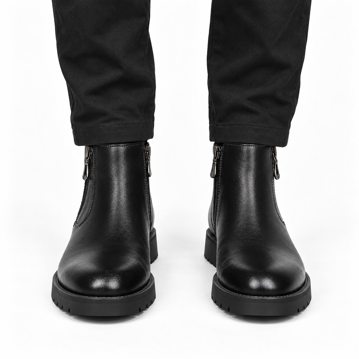 Front view of black leather ankle boots with rounded toes and thick soles