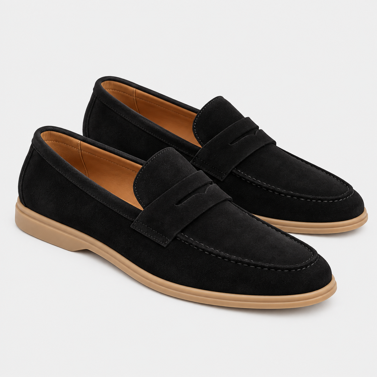 Men's black suede loafers with penny strap detail and flat rubber soles