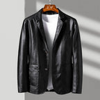 Black leather jacket on a hanger against a gray background