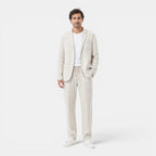 Man wearing a light beige suit on a white background