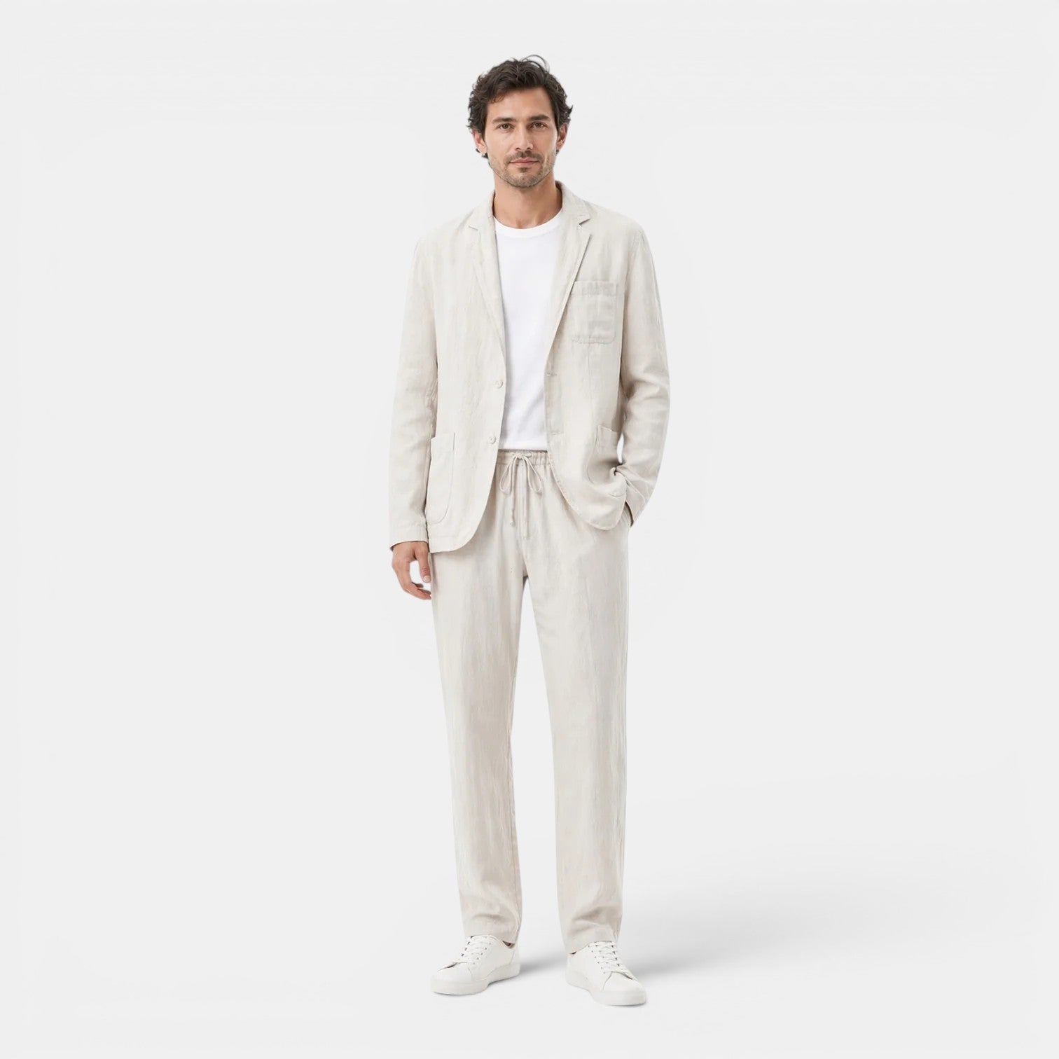 Man wearing a light beige suit on a white background