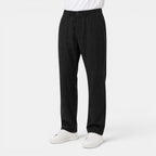 Person wearing black pants and white shoes on a white background
