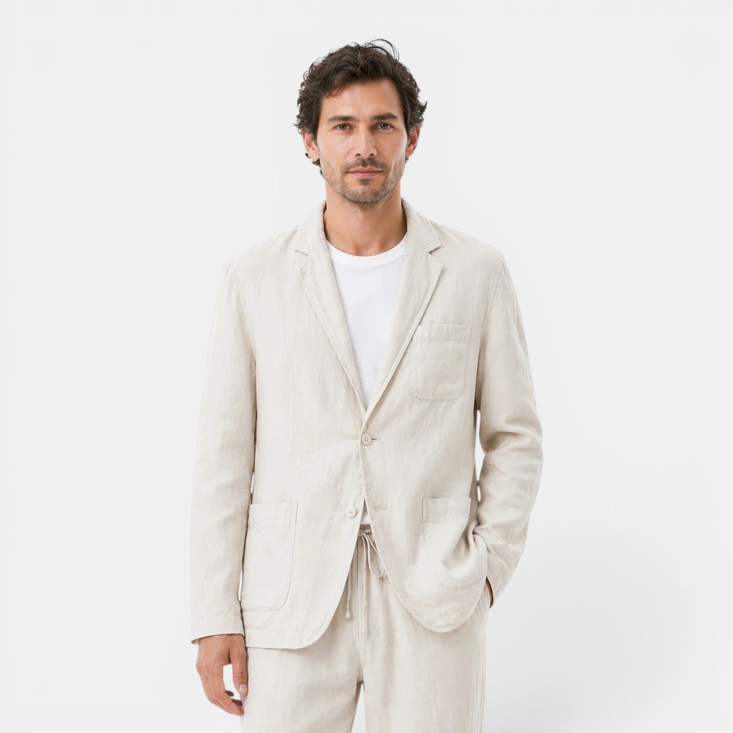 Man wearing a light beige linen suit on a white background