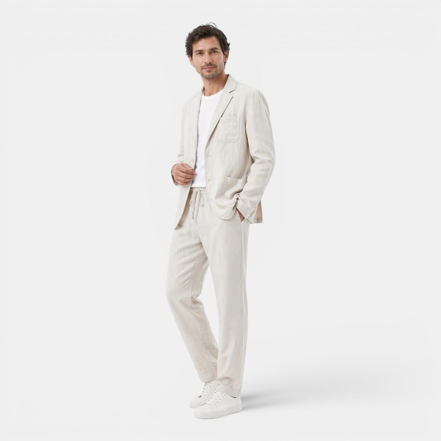 Man wearing a light-colored suit on a white background