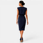 Woman wearing a navy blue dress on a white background