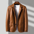 Brown leather jacket on a hanger against a neutral background