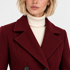 Close-up of women's burgundy coat with wide notched lapels and double-breasted buttons