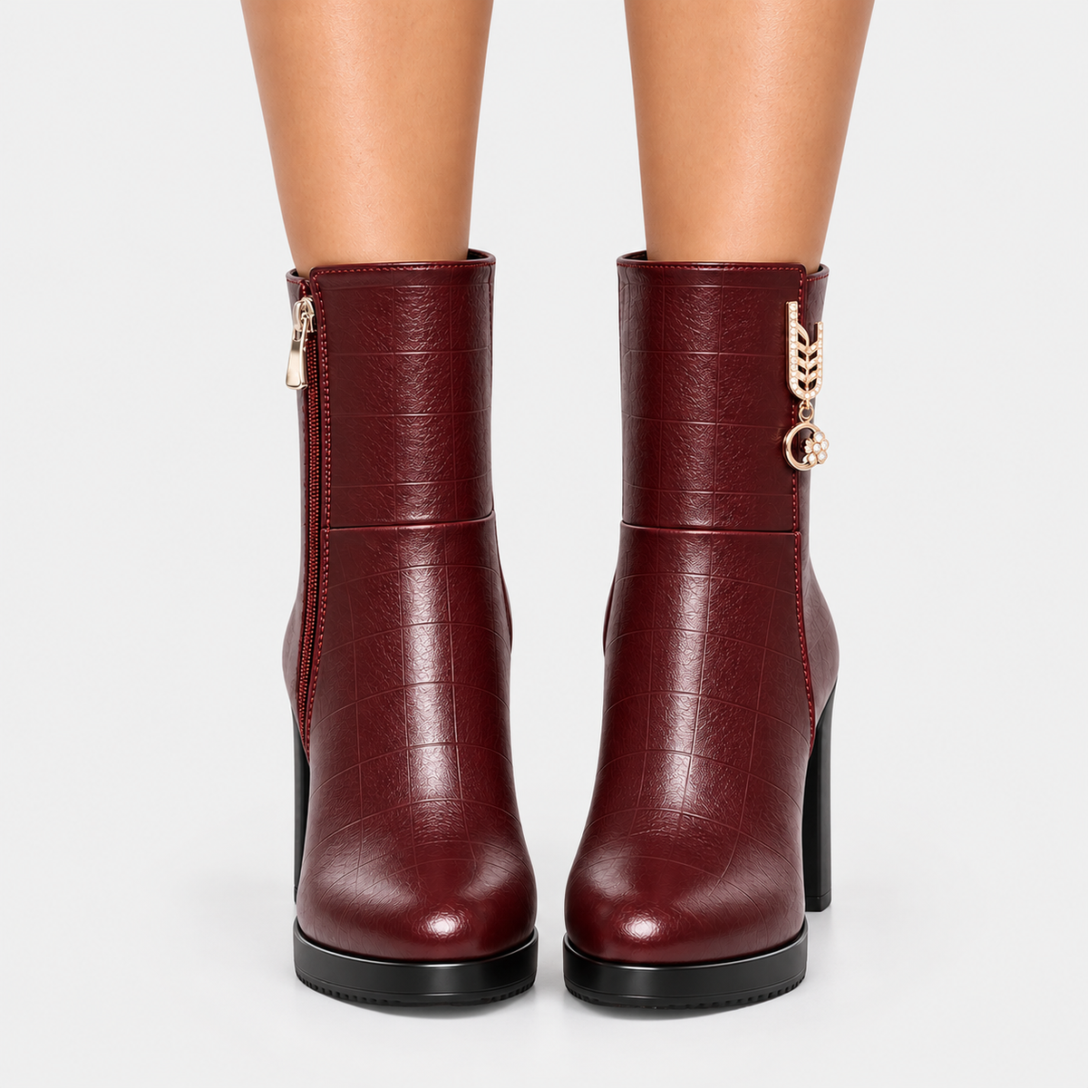 Front view of burgundy leather ankle boots with rounded toes and block heels