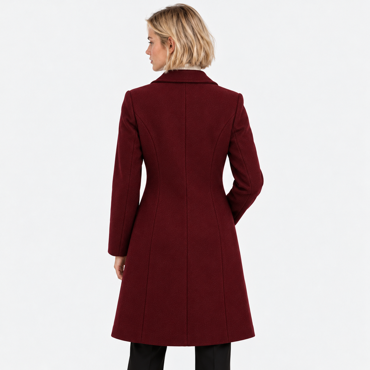 Back view of a woman wearing a burgundy long double-breasted coat