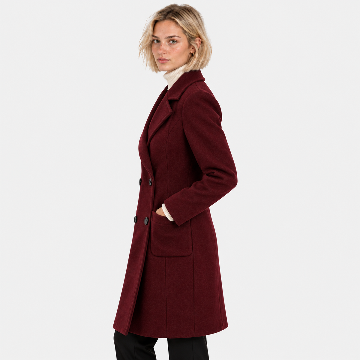 Side view of a woman wearing a burgundy double-breasted long coat