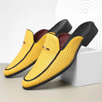 Yellow loafers with black accents on a light background