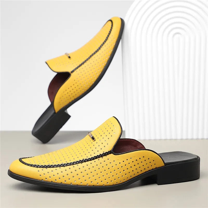 Yellow loafers with black soles on a light background