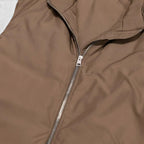 Close-up of a brown jacket with a zipper