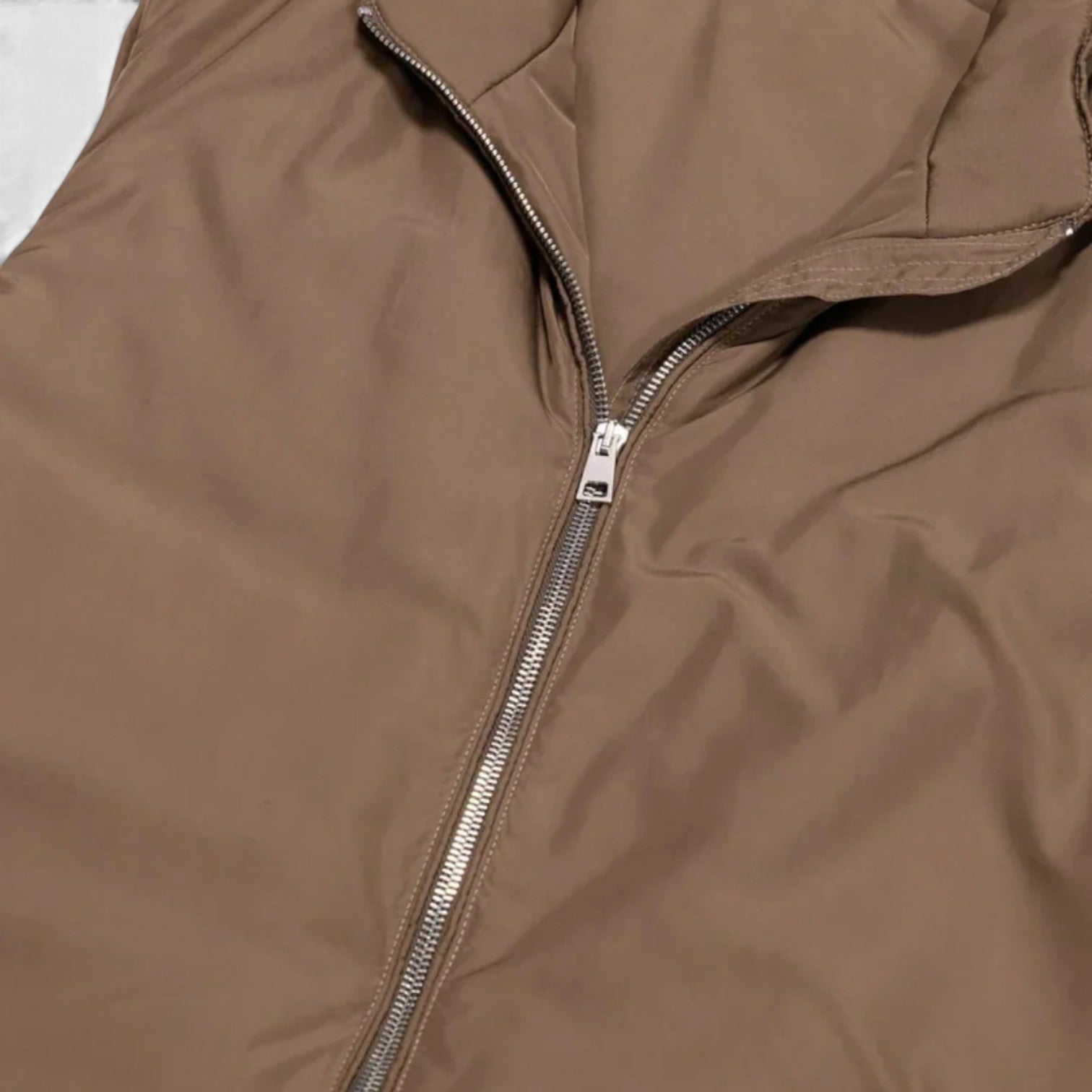 Close-up of a brown jacket with a zipper