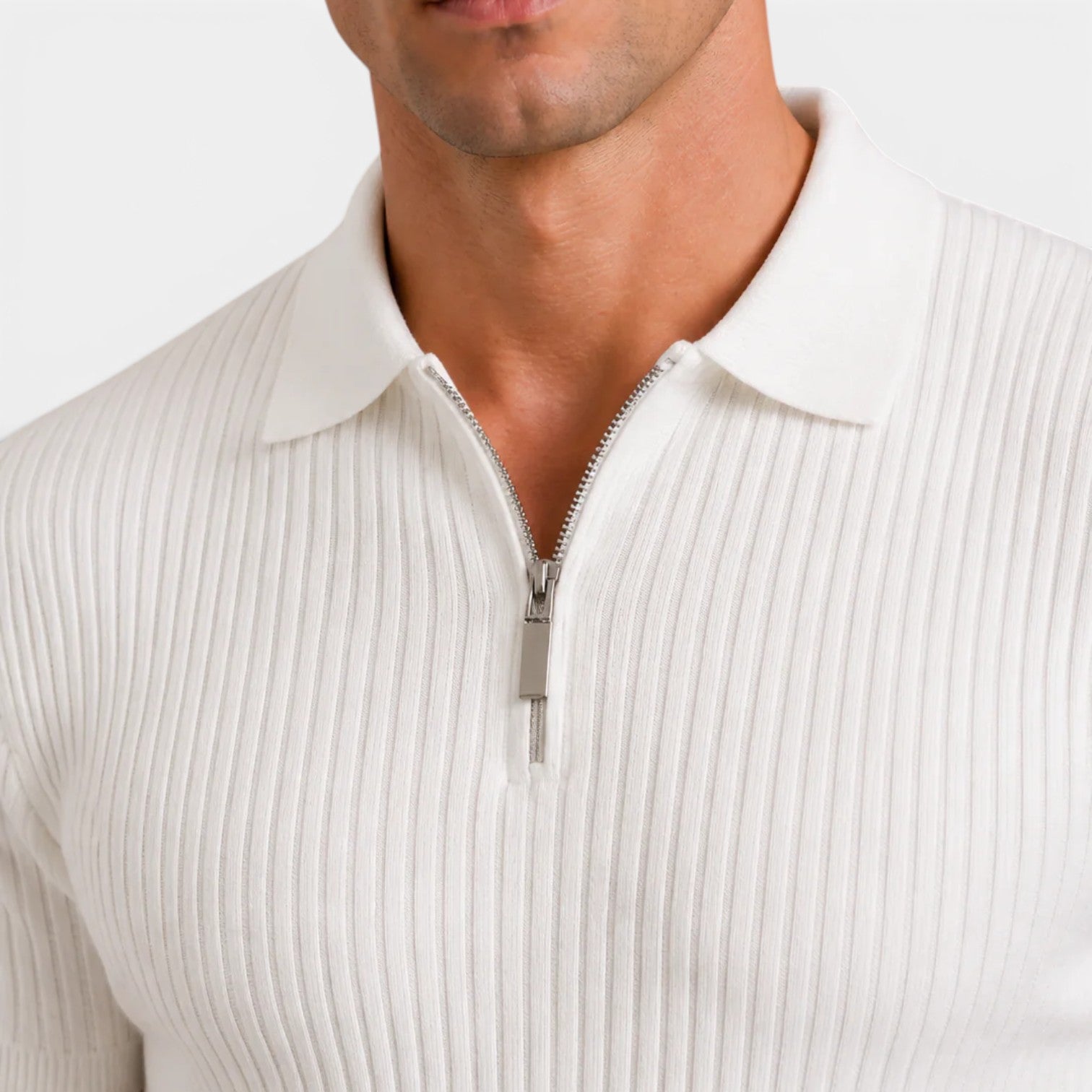 Close-up of a white ribbed knit polo shirt with a silver quarter-zip collar detail.