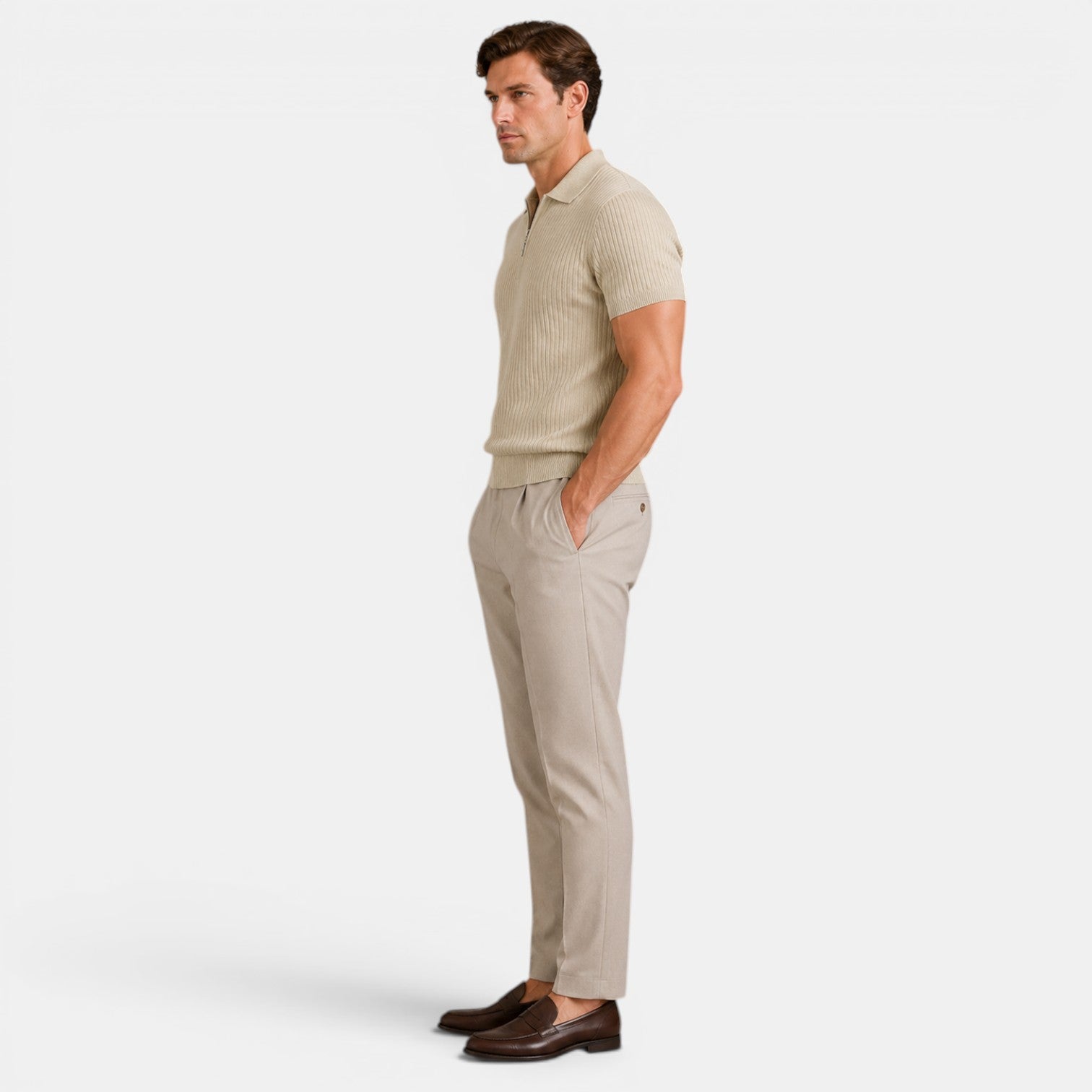 Side view of a man wearing a beige ribbed knit polo shirt with matching trousers and brown loafers.