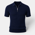 Navy ribbed knit polo shirt with a quarter-zip collar, displayed against a light gray background.