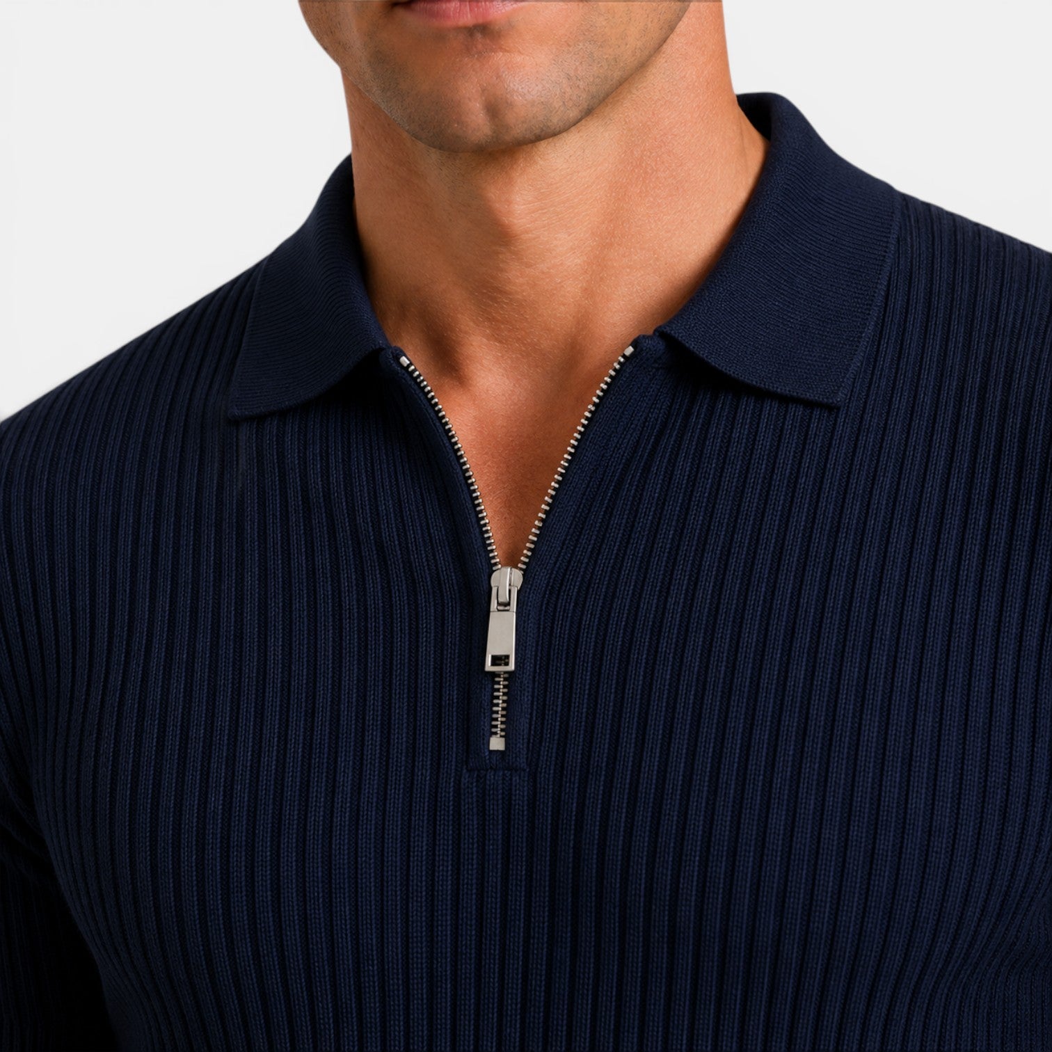 Close-up of a navy ribbed knit polo shirt with a silver quarter-zip collar detail.