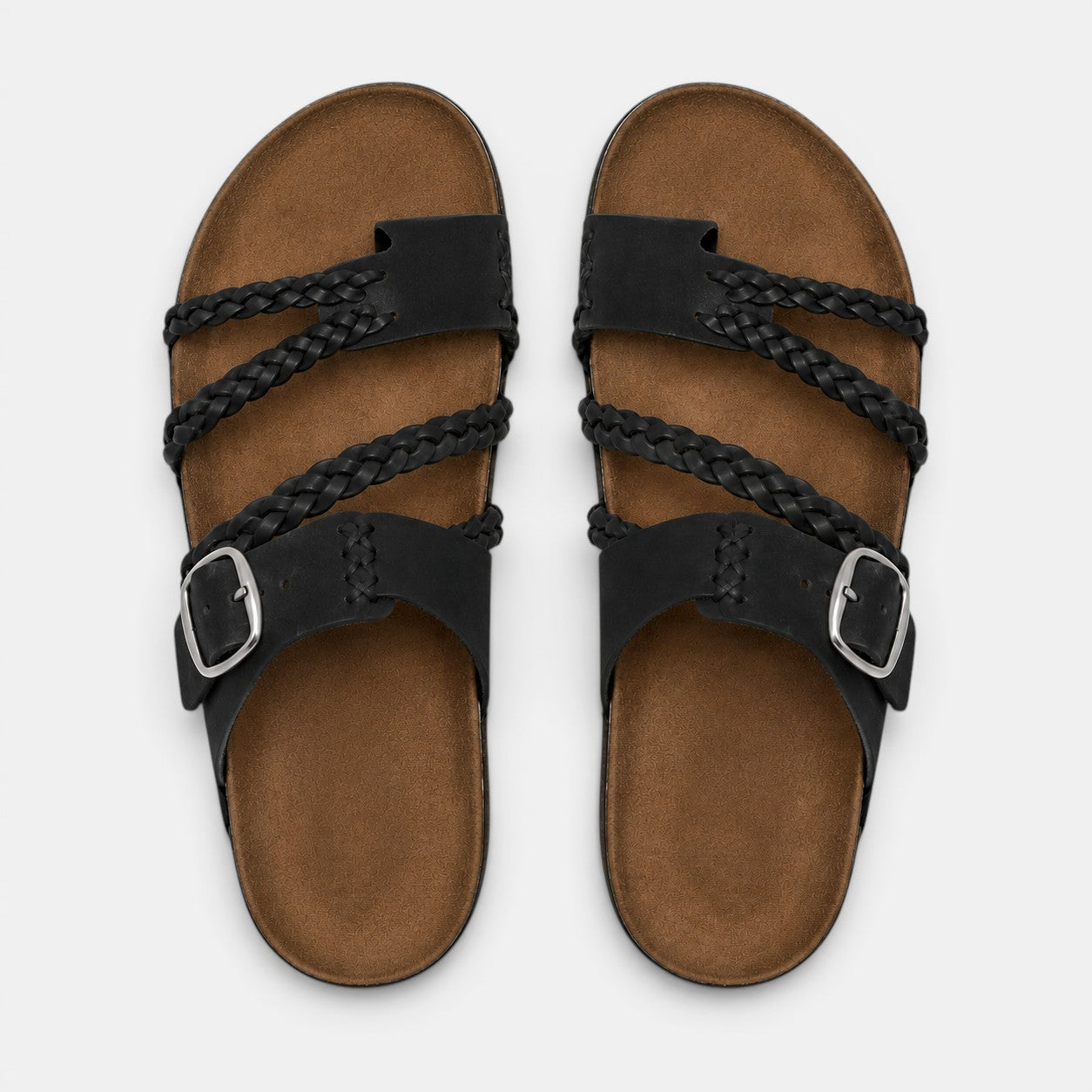 Top view of black braided strap sandals with adjustable buckles and brown footbeds.