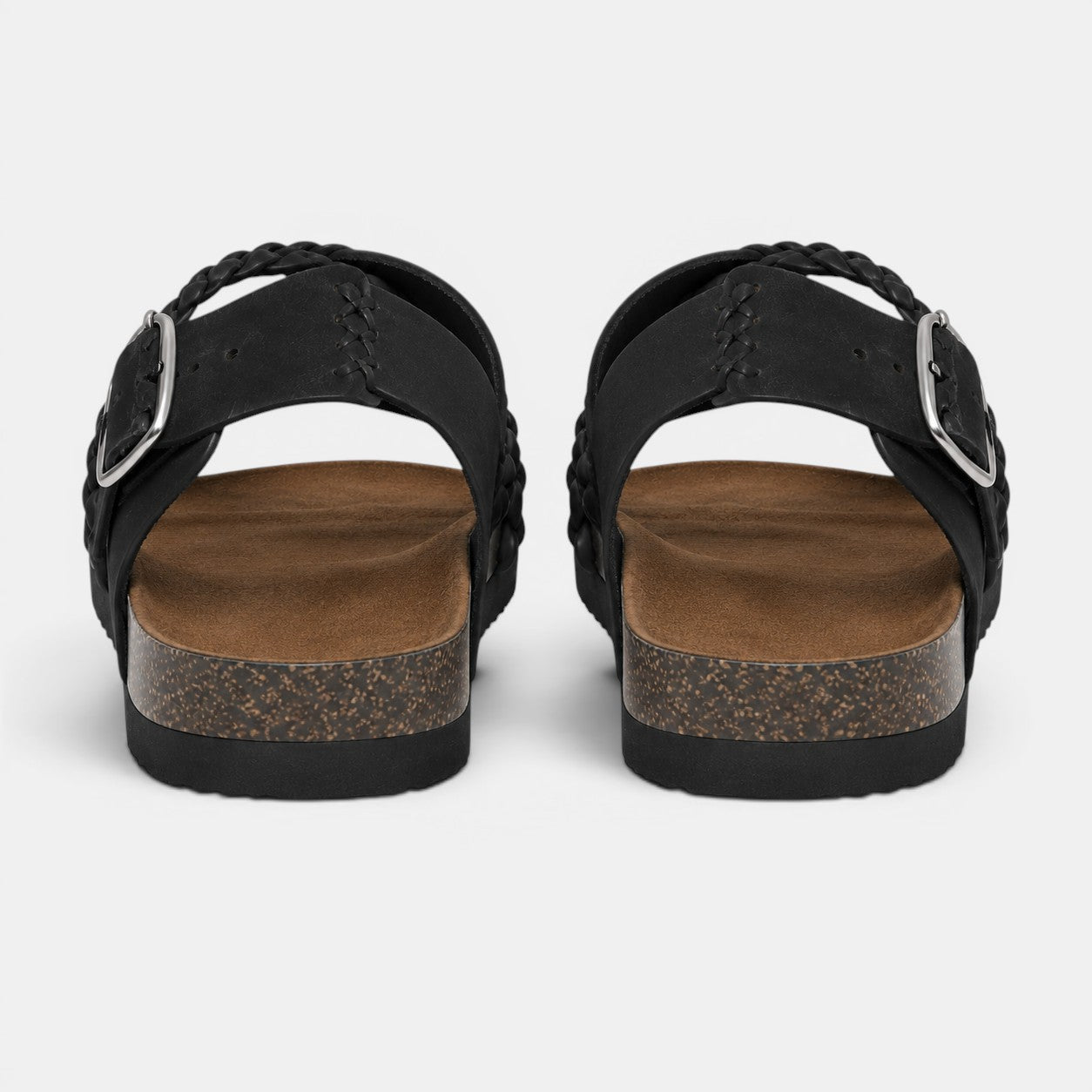 Back view of black braided strap sandals with adjustable buckles and cork-style soles.