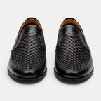 Front view of black perforated leather loafers with a breathable slip-on design.