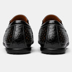 Back view of black perforated leather loafers with a breathable slip-on design.