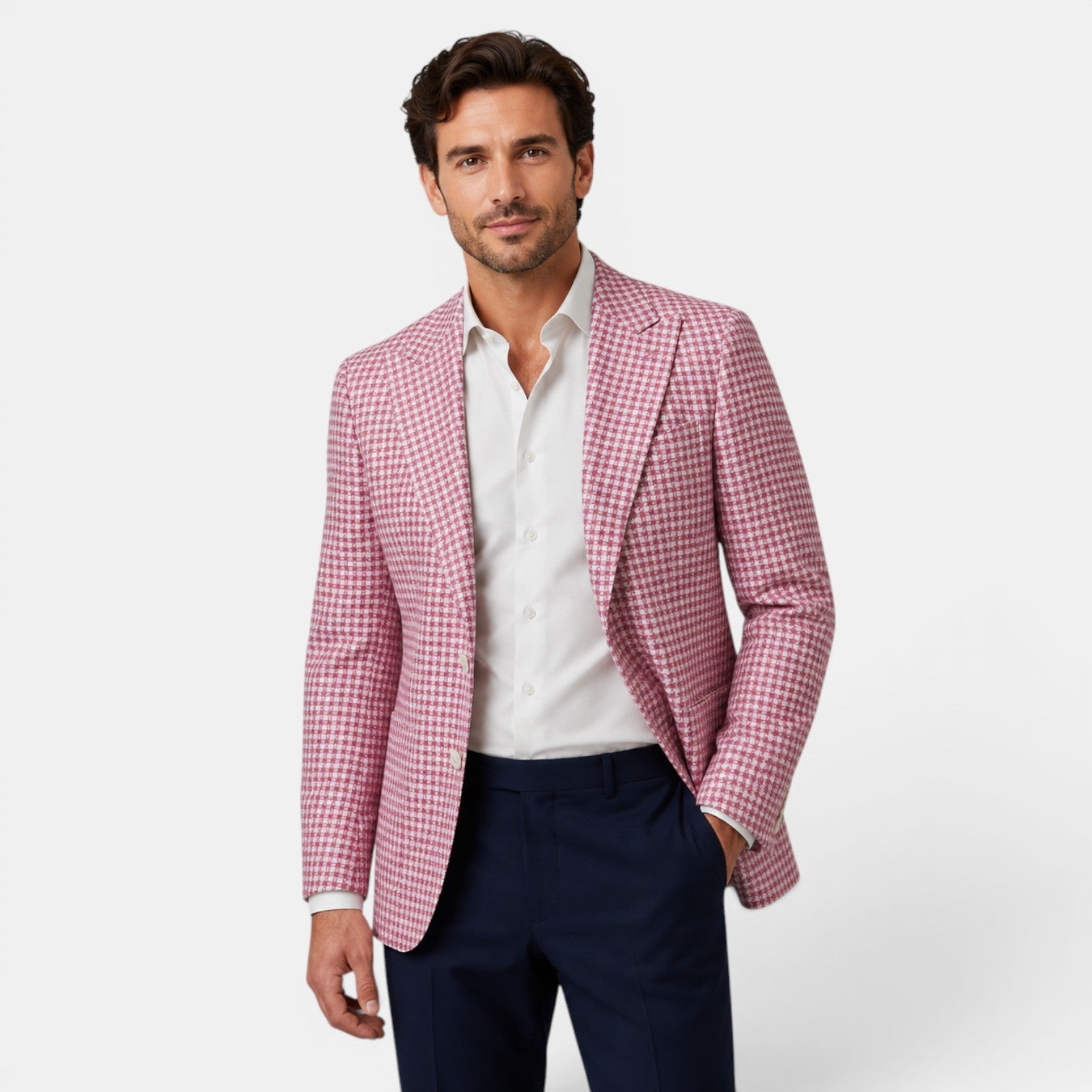 Young man wearing a pink checked blazer, white dress shirt, and navy trousers.