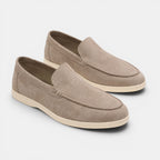 Pair of brown loafers on a light gray background
