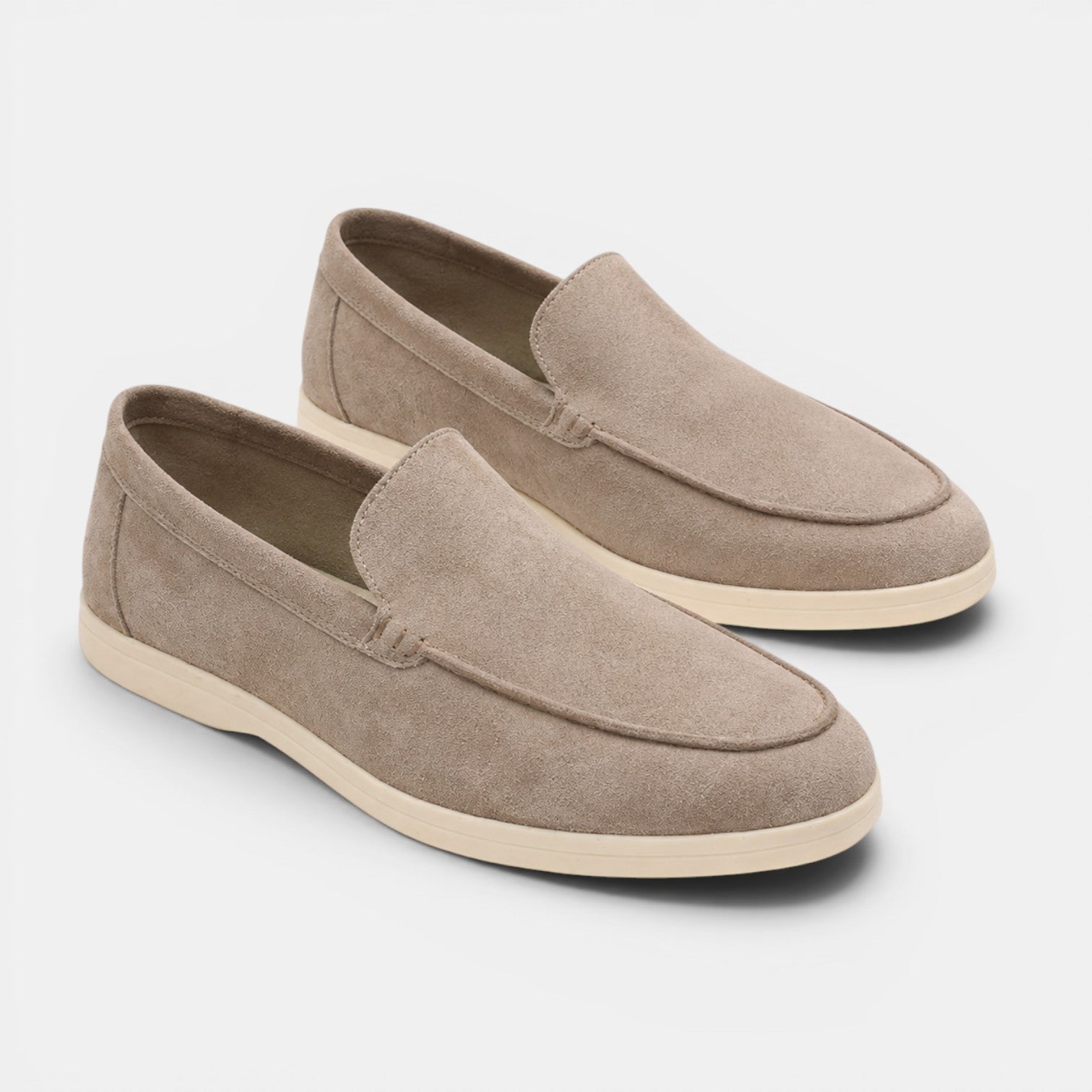 Pair of brown loafers on a light gray background