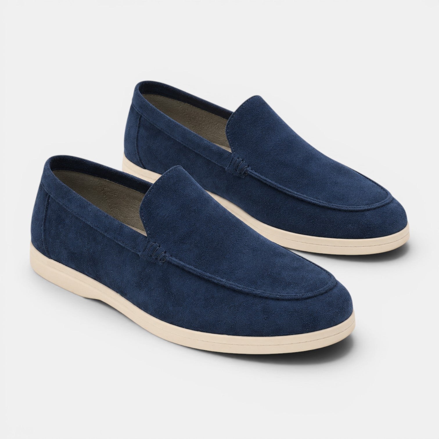 Pair of navy blue loafers on a light gray background