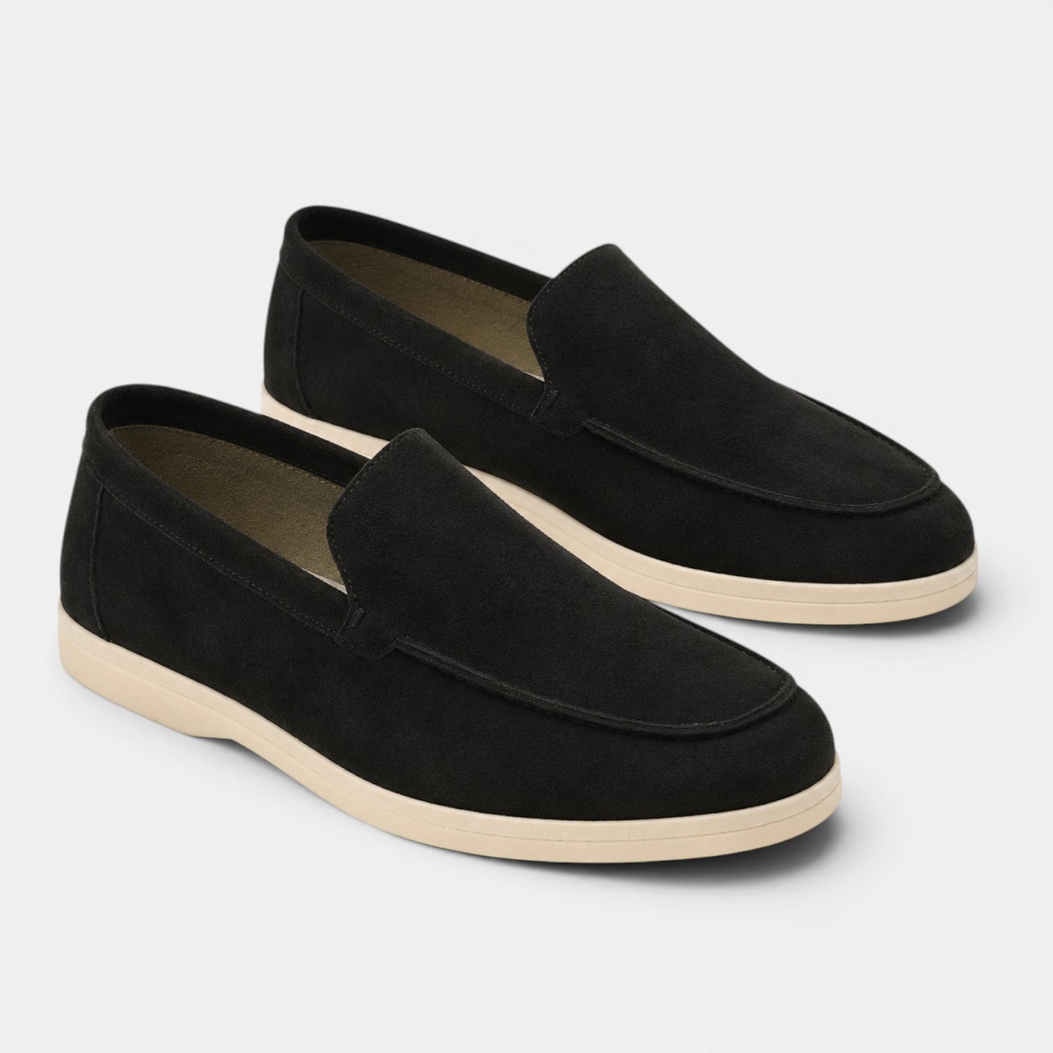 Pair of black loafers on a light gray background