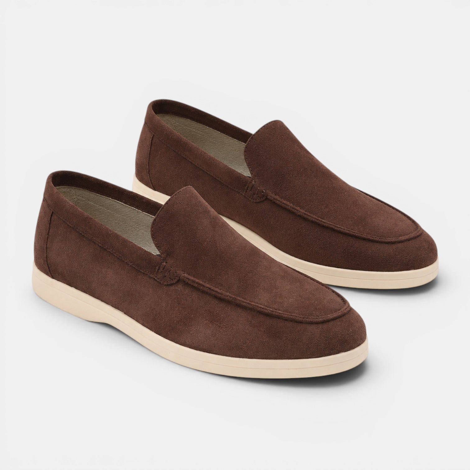Pair of brown loafers on a light gray background