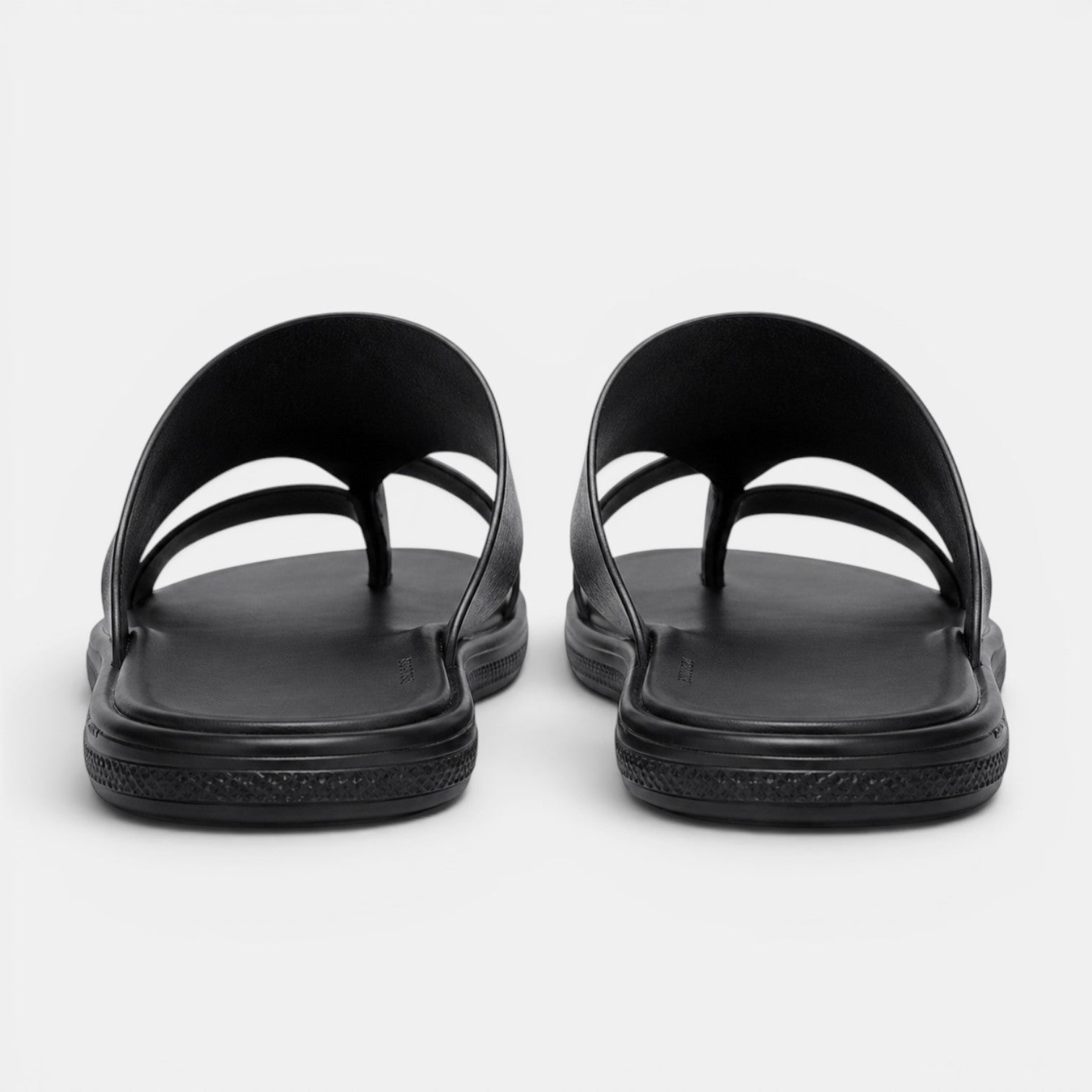 Pair of black sandals on a white background