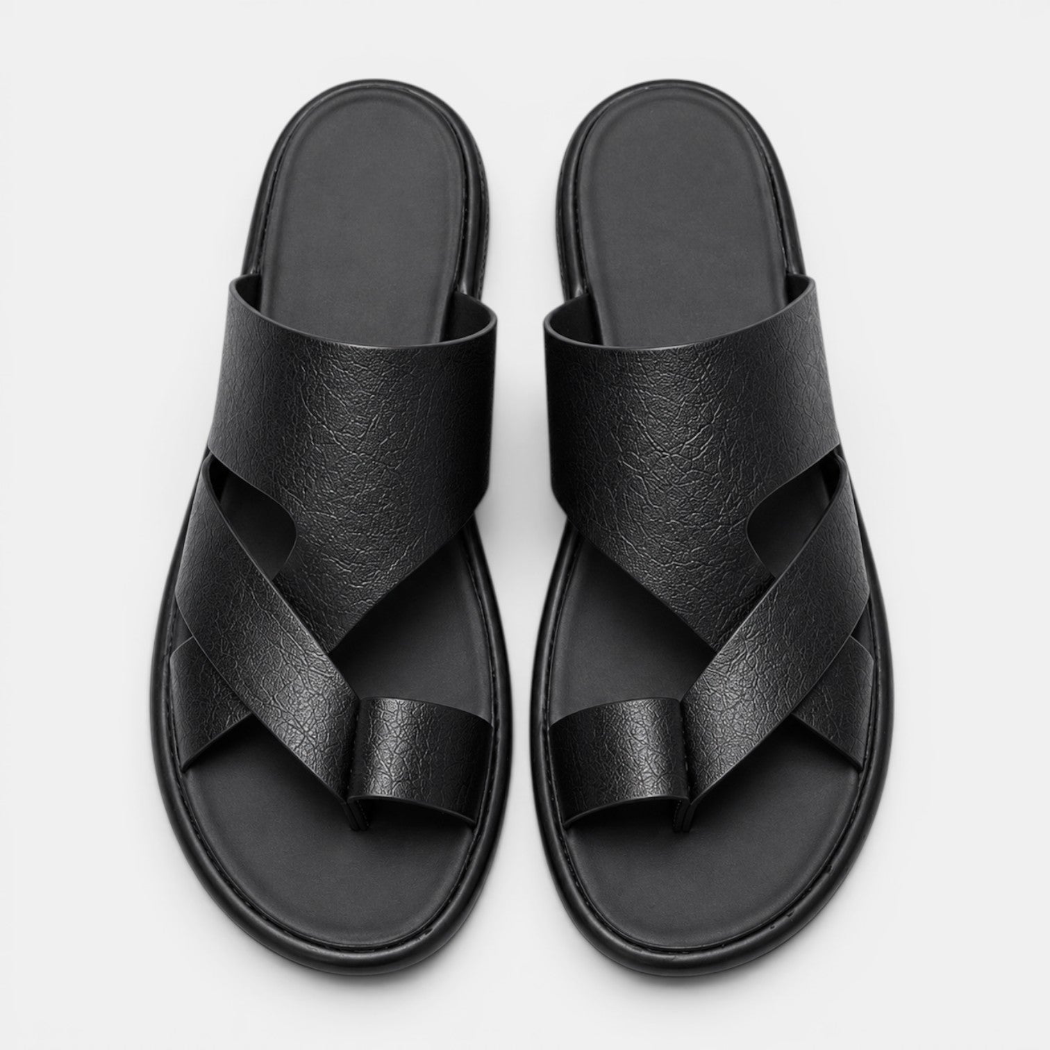 Pair of black sandals on a light gray background