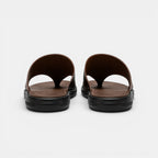 Pair of brown sandals with black soles on a white background