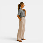 Woman wearing a gray blazer and beige pants on a white background