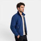 Man wearing a blue jacket on a light gray background
