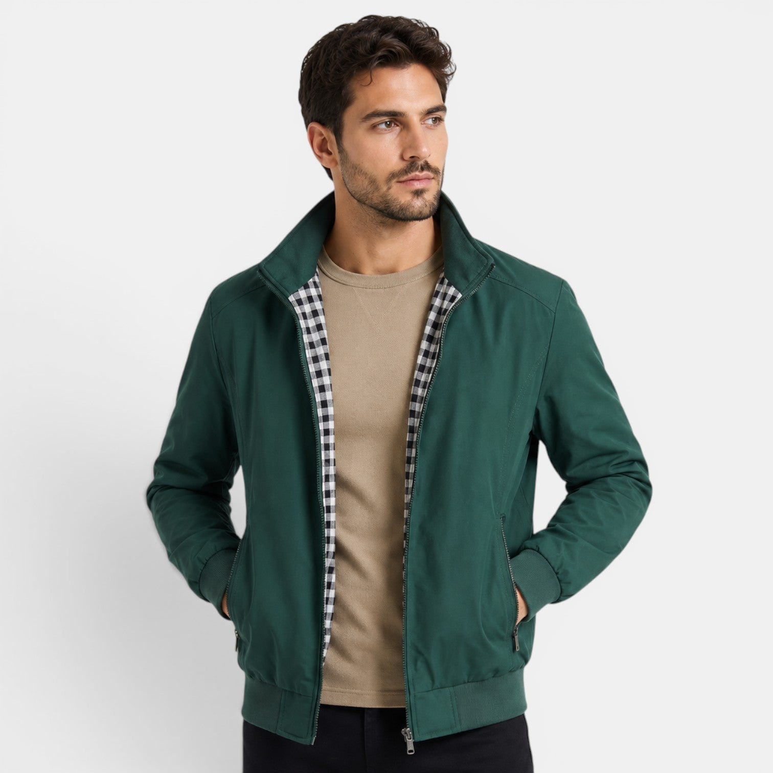 Man wearing a green jacket with plaid lining on a white background