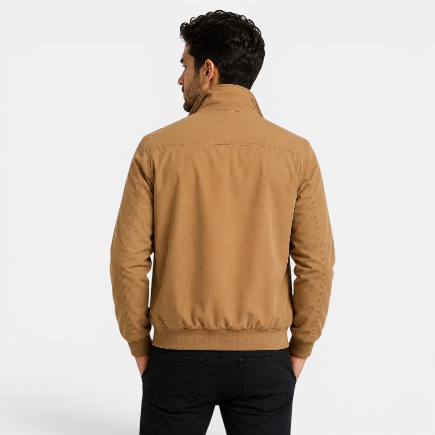 Man wearing a tan jacket on a white background