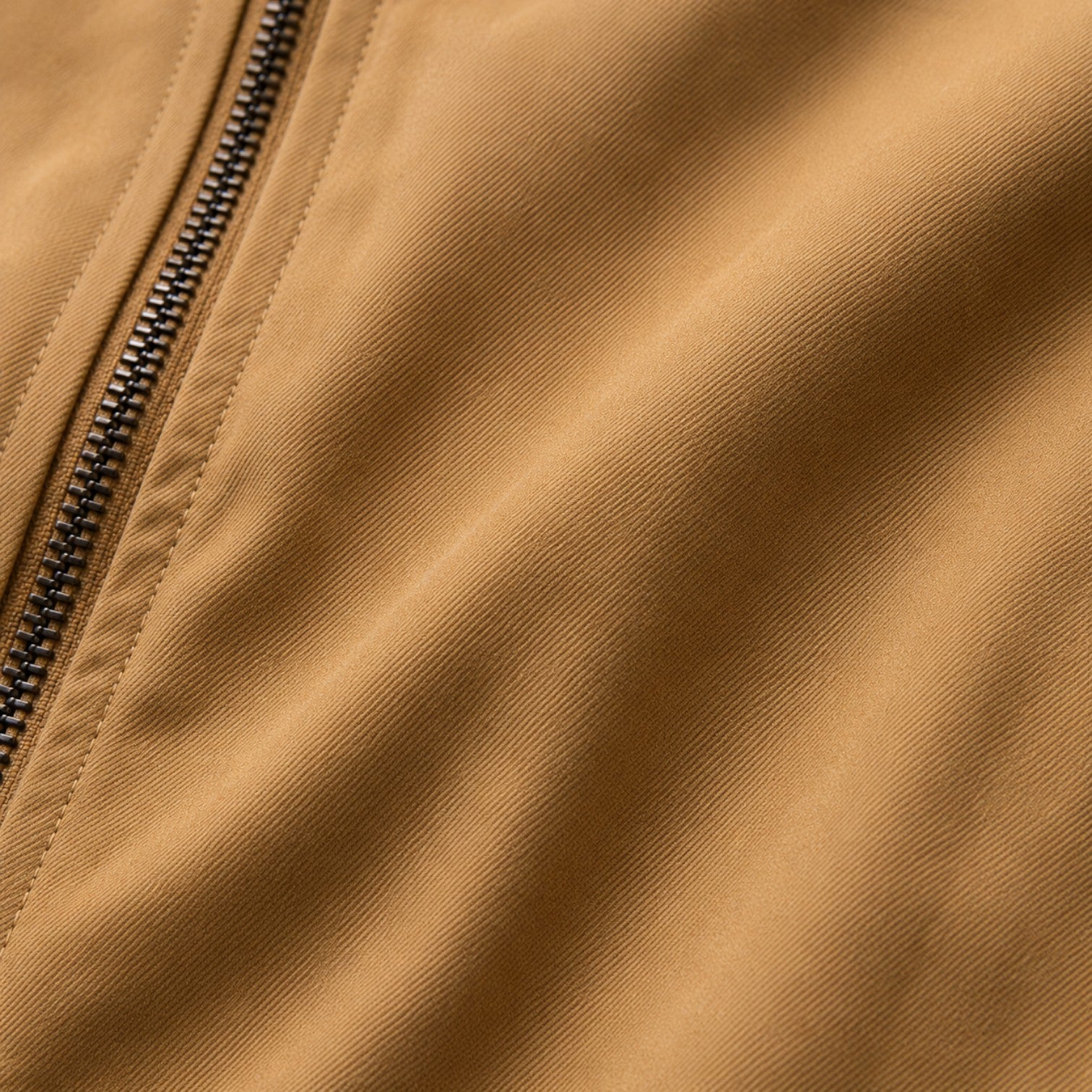 Close-up of a brown jacket with a zipper