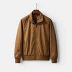 Brown jacket on a hanger against a white background