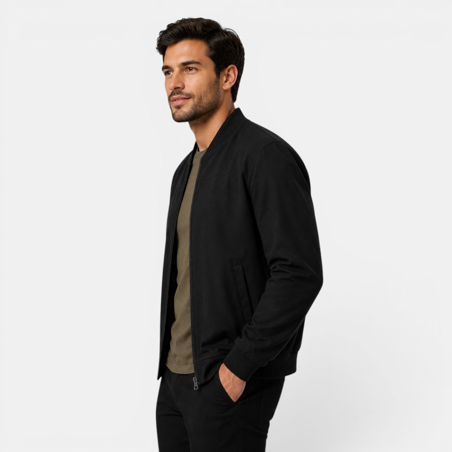 Man wearing a black jacket over a green shirt on a white background