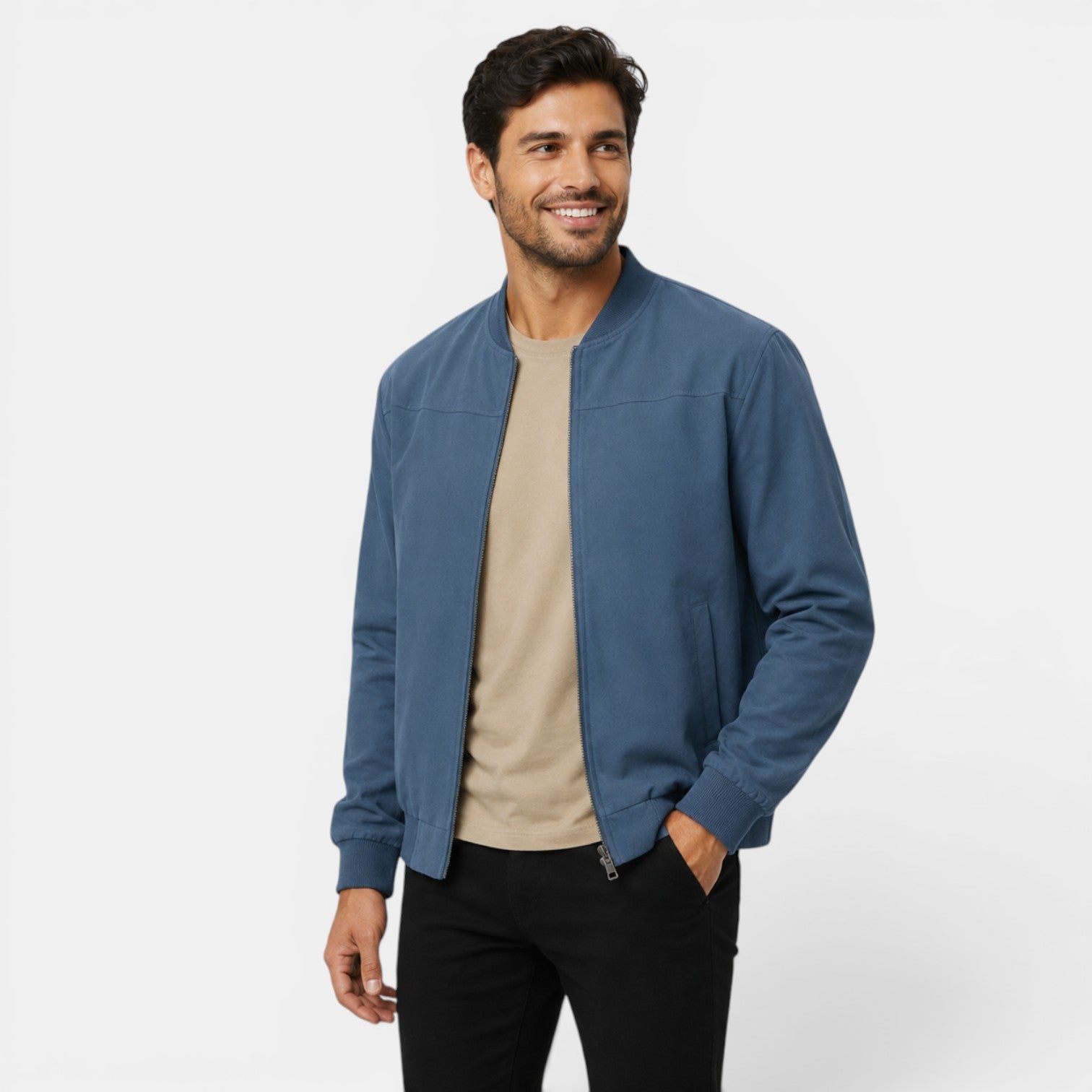 Man wearing a blue jacket over a beige shirt on a white background