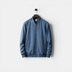 Blue jacket on a hanger against a white background