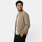 Man wearing a beige jacket on a white background