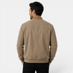 Man wearing a beige jacket on a white background