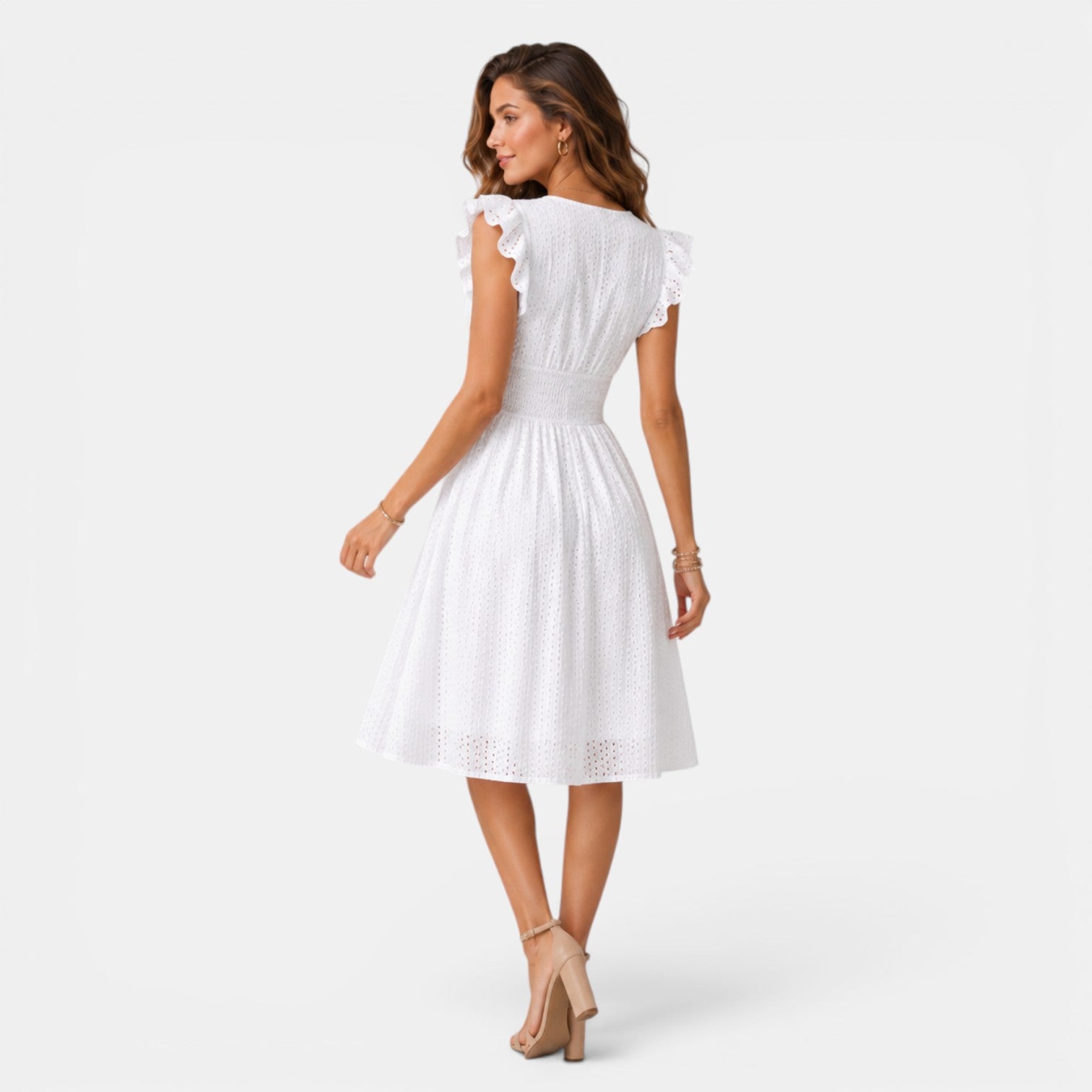 Woman wearing a white dress on a plain background