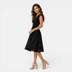 Woman wearing a black dress on a white background