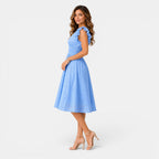 Woman wearing a light blue dress on a white background