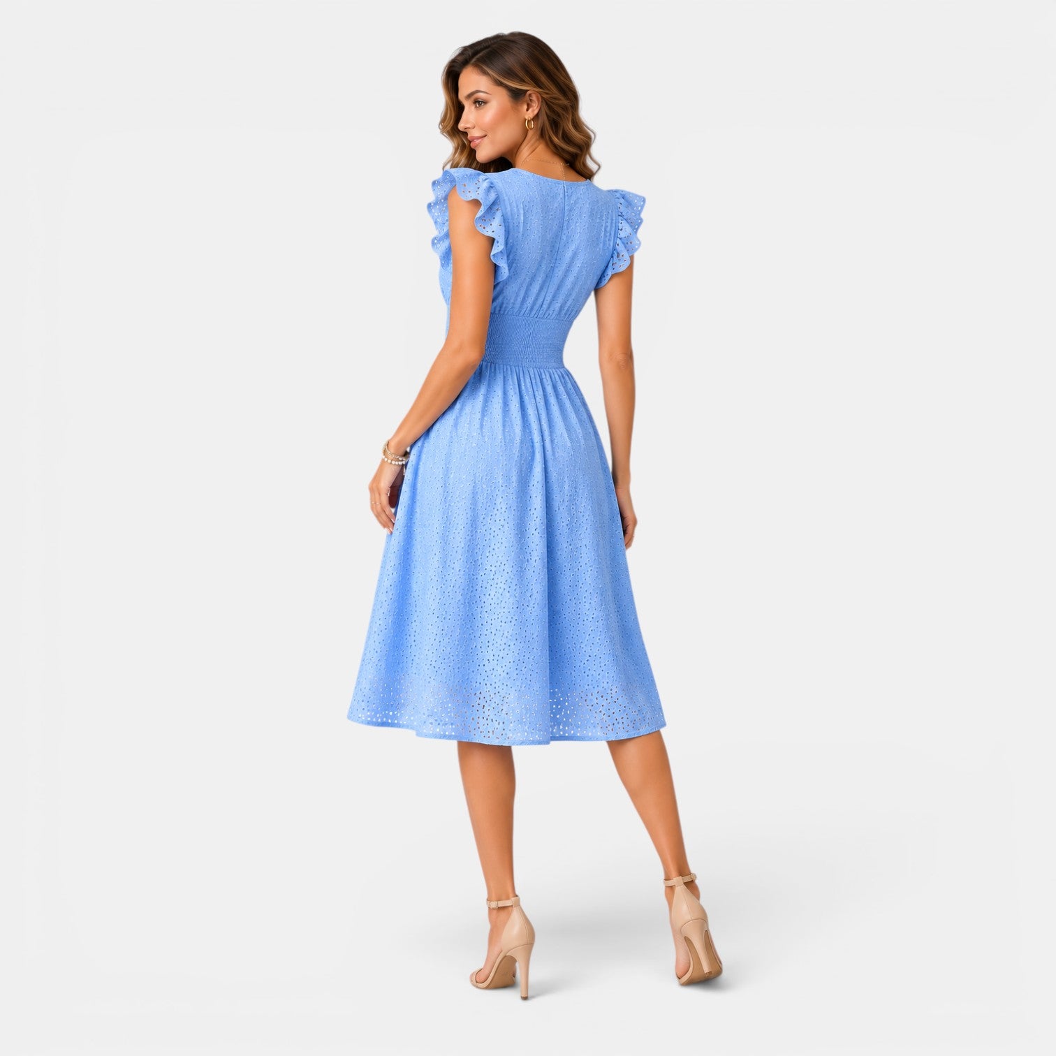 Woman wearing a light blue dress with ruffled sleeves on a white background